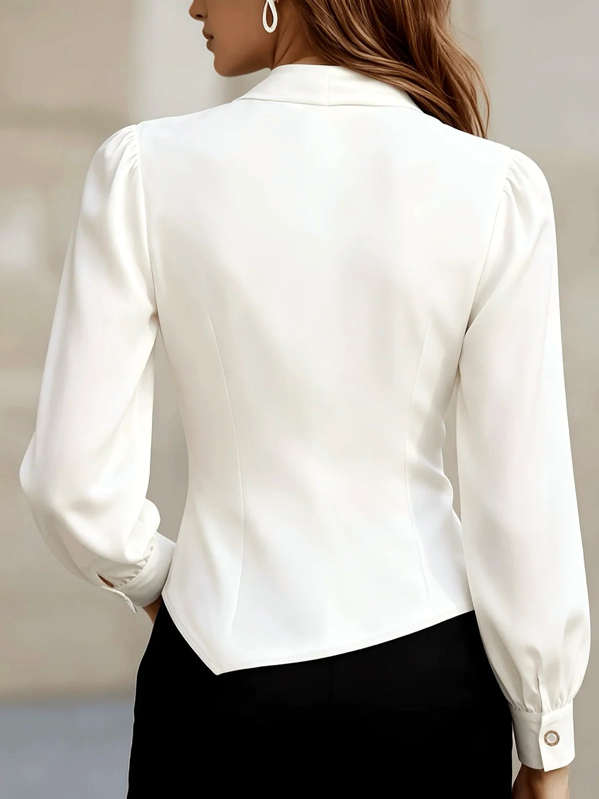 Women's draped button-front asymmetric blouse in white, back model view.