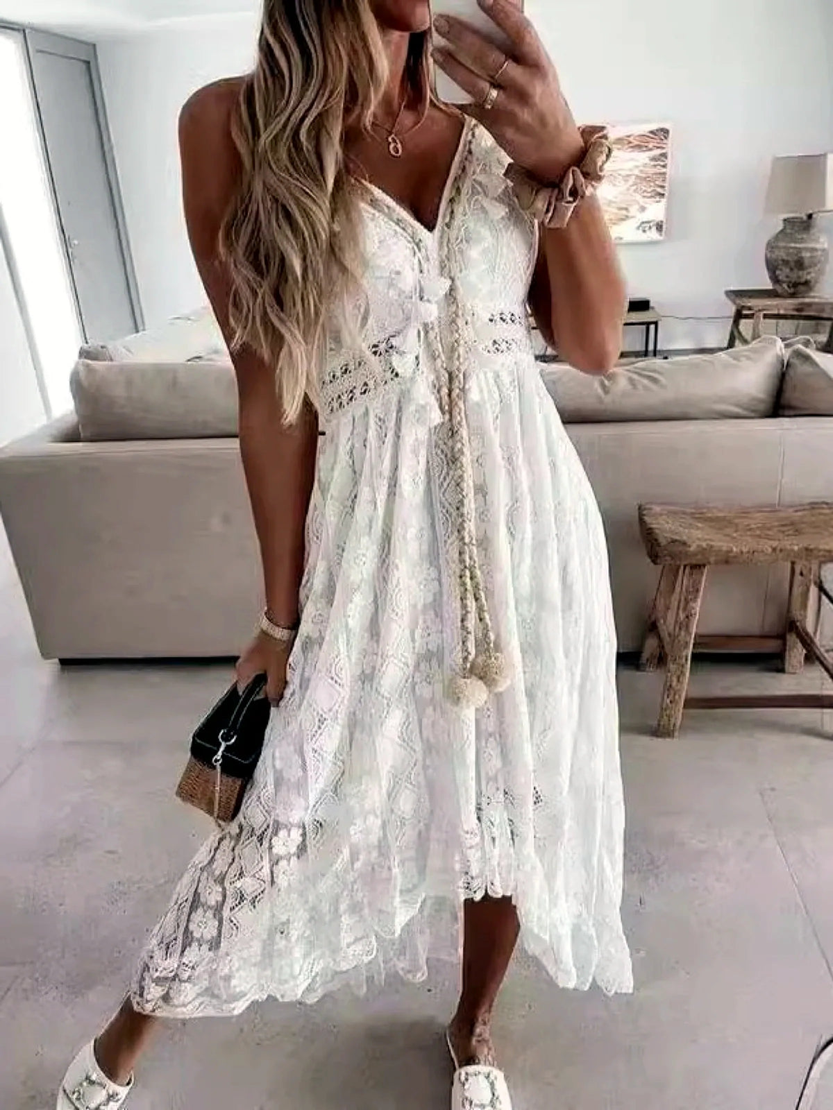 Women's sleeveless lace high-low dress in white, lace and bodice detail.