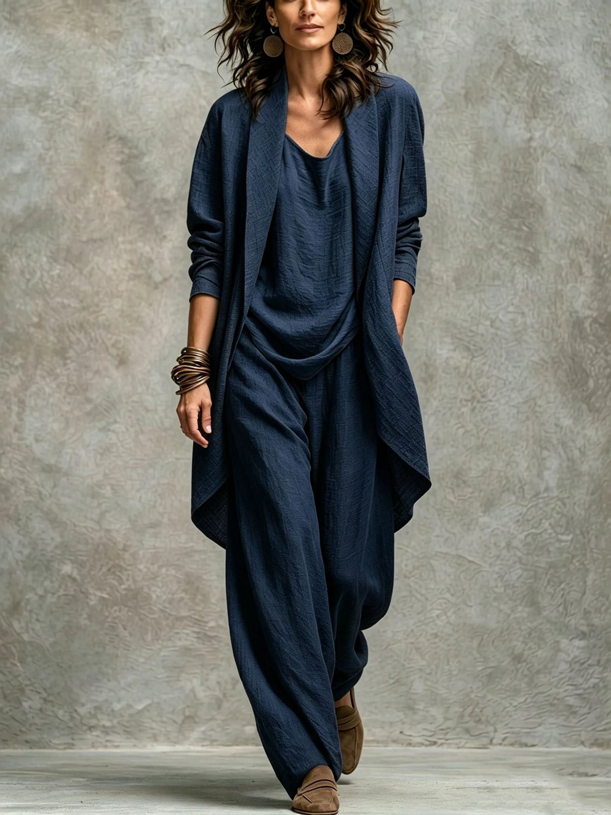 Women’s navy textured asymmetric top and wide-leg pants set with an open-front layer, showing the relaxed drape.