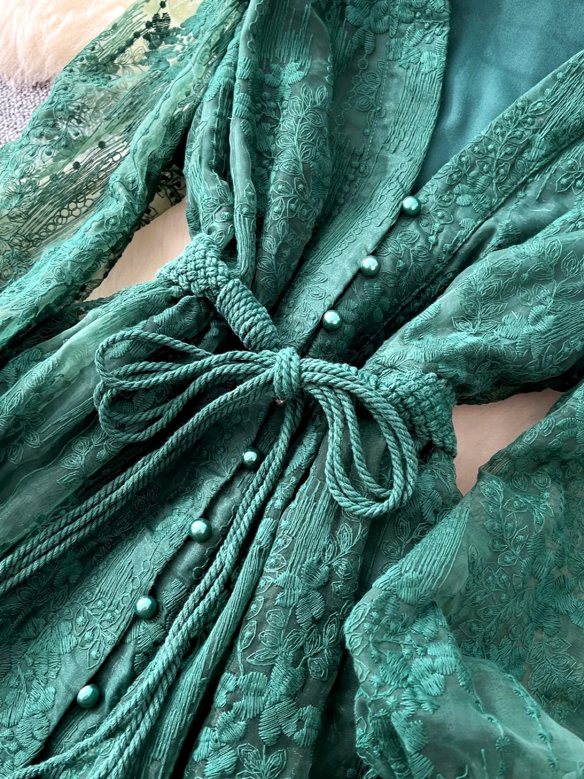 Women's V-neck floral lace long-sleeve dress in green, lace and waist tie detail.