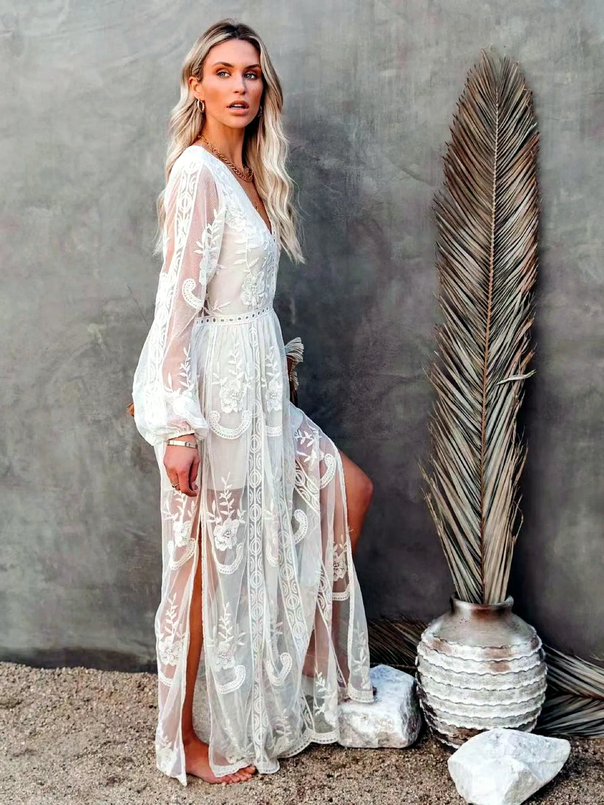 Women's V-neck long-sleeve sheer lace maxi dress in white, side slit view.
