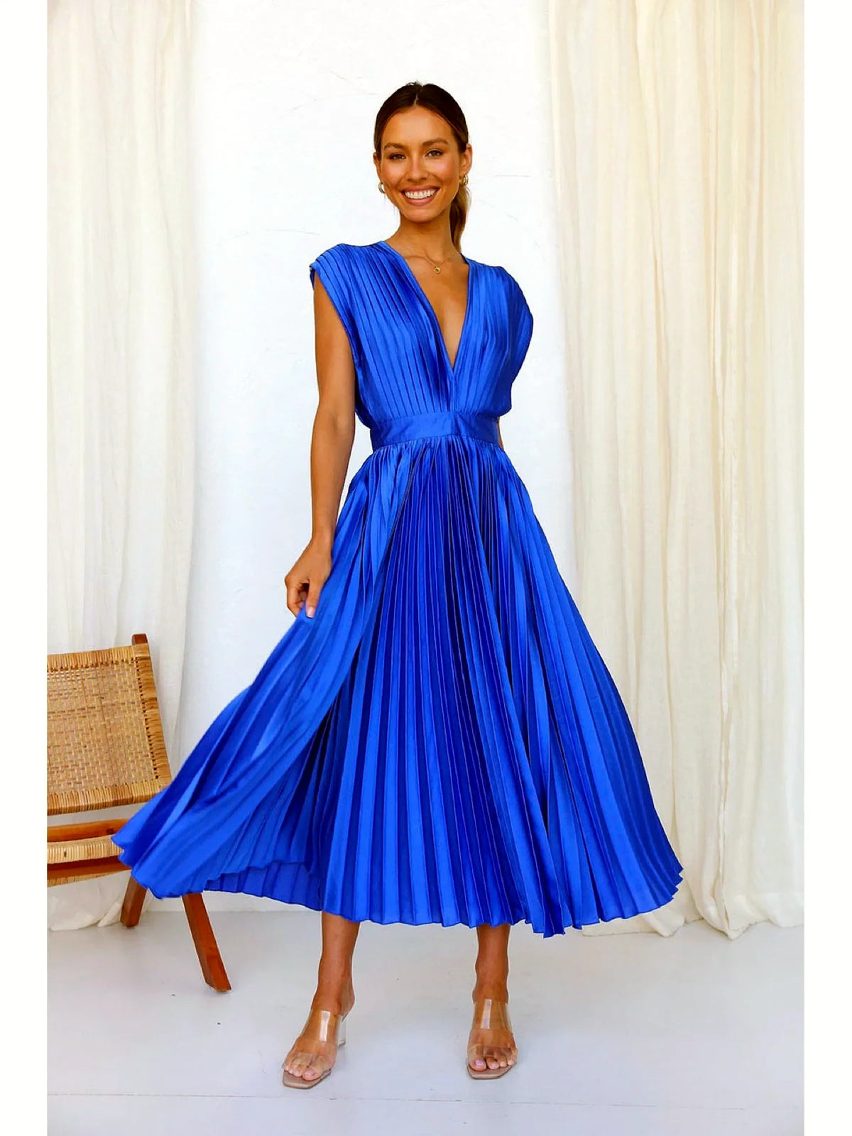 Women's V-neck pleated midi dress in blue, twirl model view.