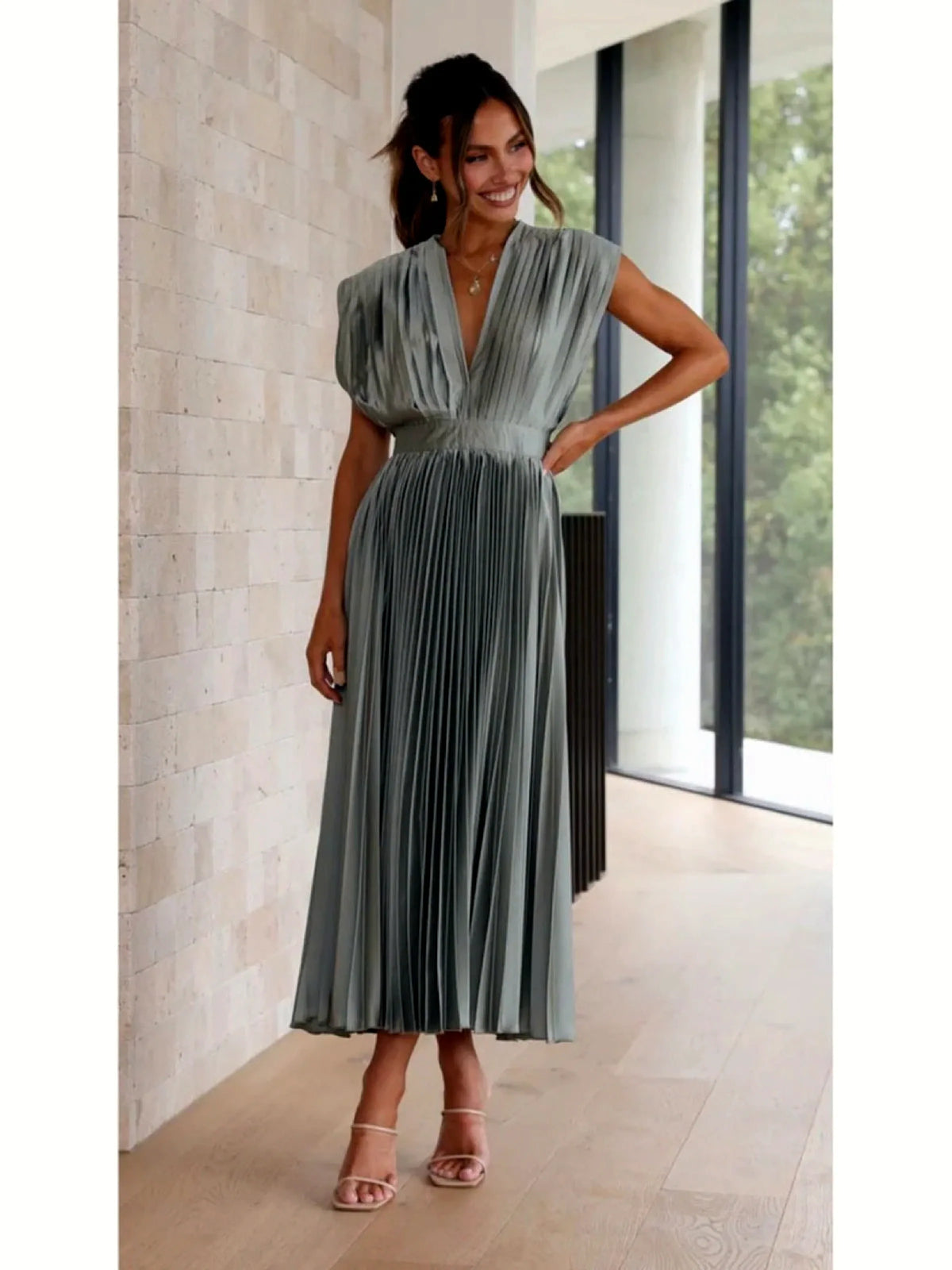 Women's V-neck pleated midi dress in gray, front model view.