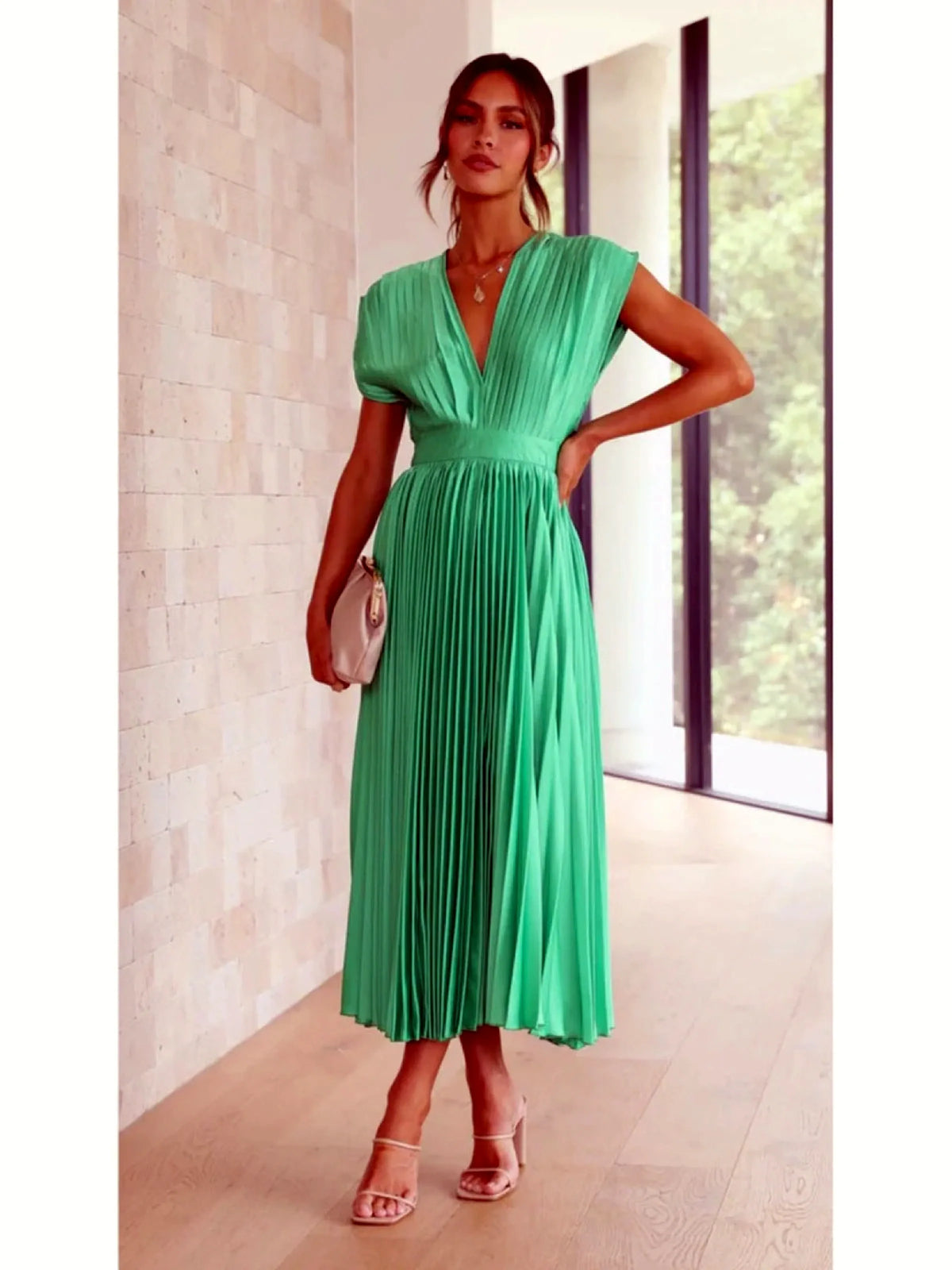 Women's V-neck pleated midi dress in green, front model view.