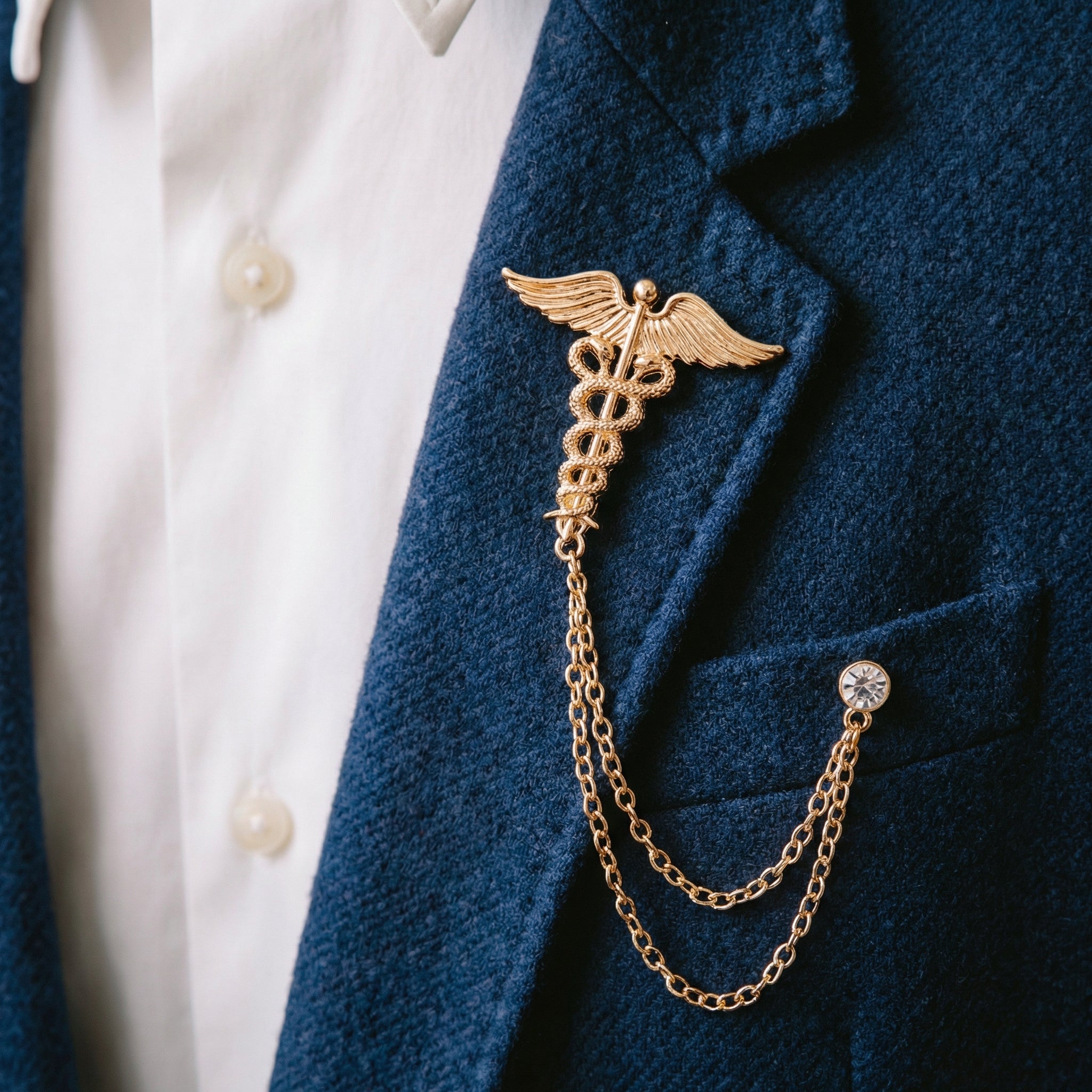 Lapel pins with chains, winged double serpent staff