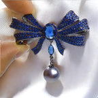 Blue Copper Bow Brooch: Zircon Pearl Pendant
