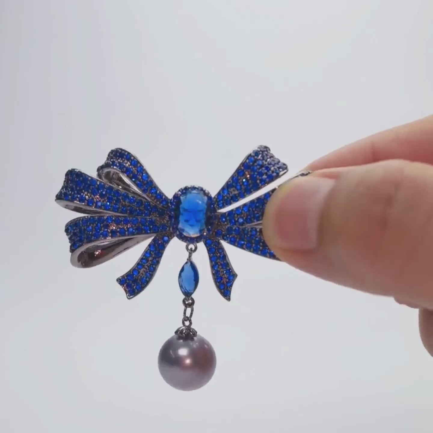 Load video: Blue Copper Bow Brooch: Zircon Pearl Pendant