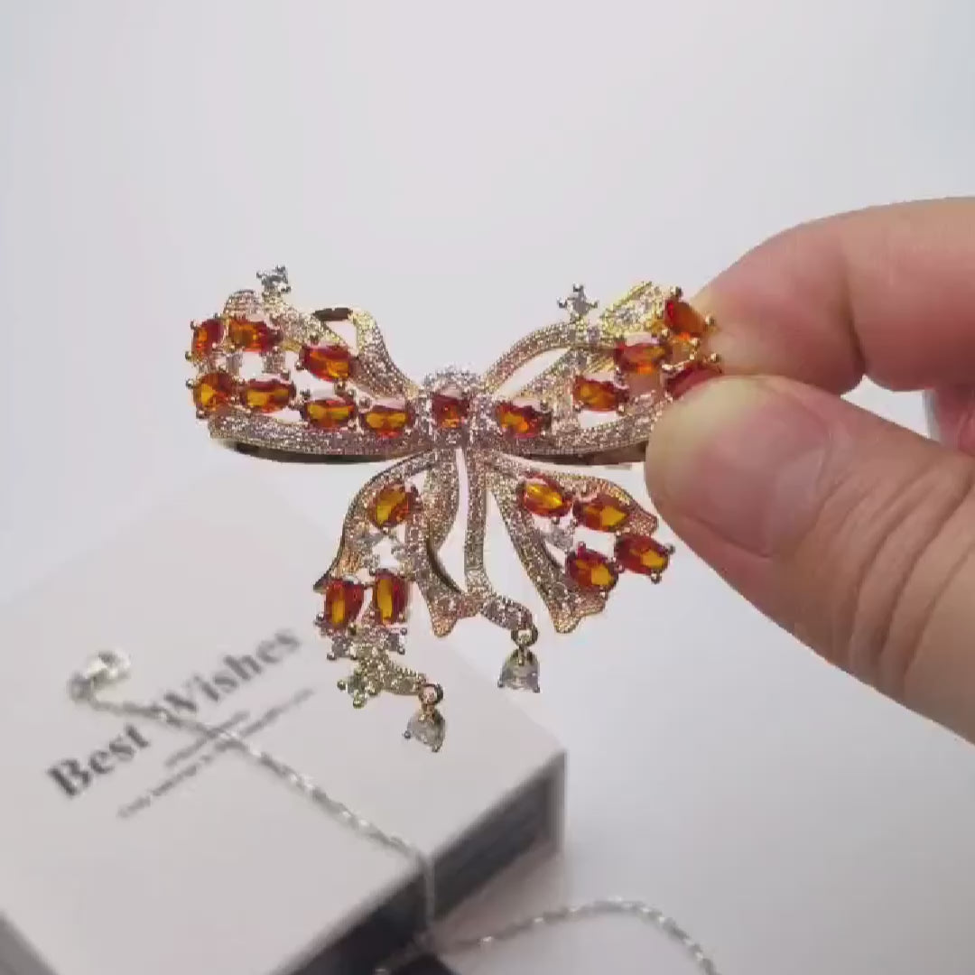 Load video: Palace French retro bow brooch inlaid with orange zircon