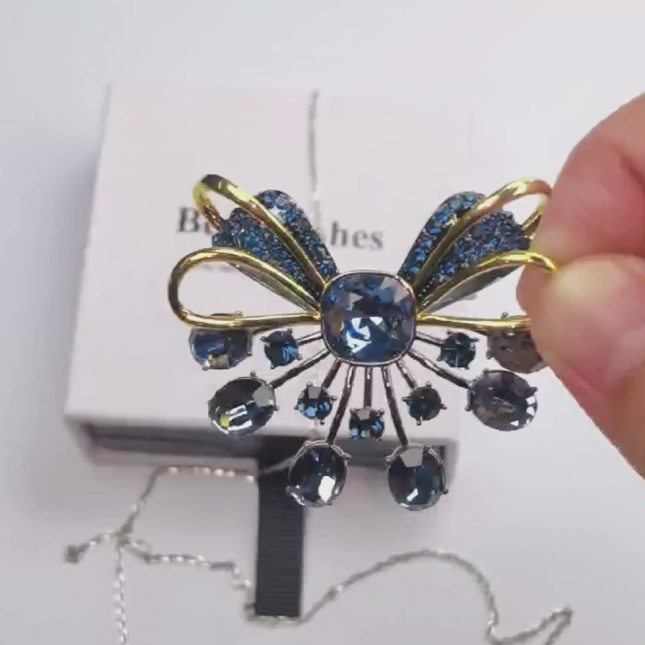Load video: Retro palace style black bow brooch inlaid with blue zircon crystal