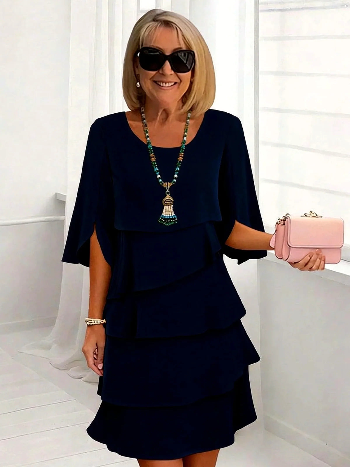 Women's layered ruffle relaxed midi dress in navy, front model view.