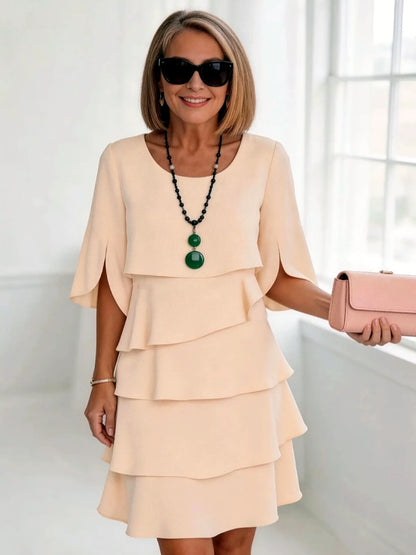 Women's layered ruffle relaxed midi dress in peach, front model view.