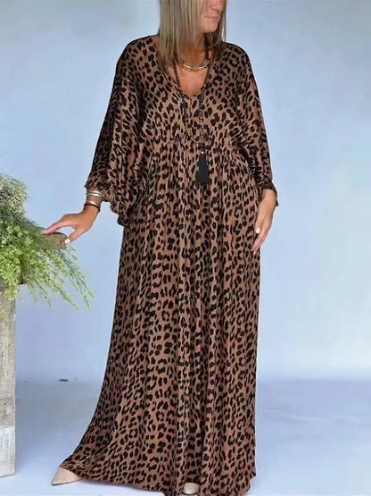 Women's leopard-print V-neck maxi dress in brown and black, front model view.