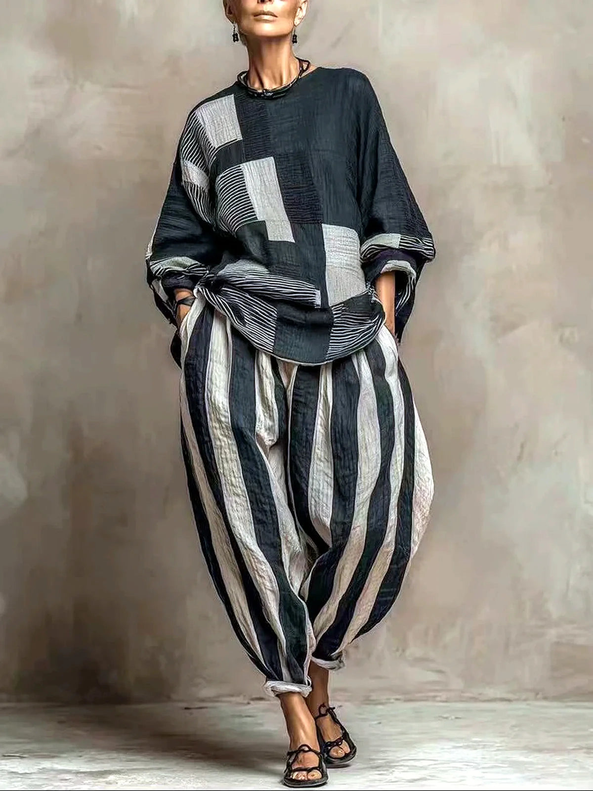 Women's patchwork top and striped relaxed pants set in black and gray, front model view.