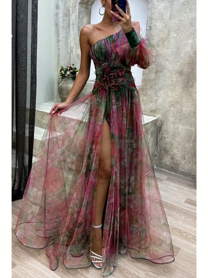 Women's printed one-shoulder floral-waist slit gown in green and pink, front mirror view.