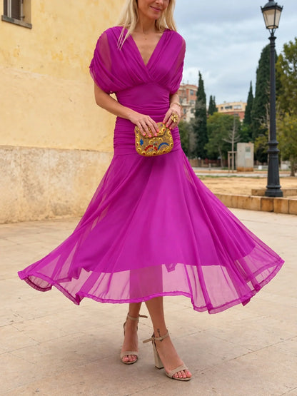 Women's ruched off-shoulder flowing dress in purple, front twirl view.