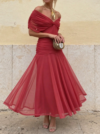 Women's ruched off-shoulder flowing dress in red, front model view.