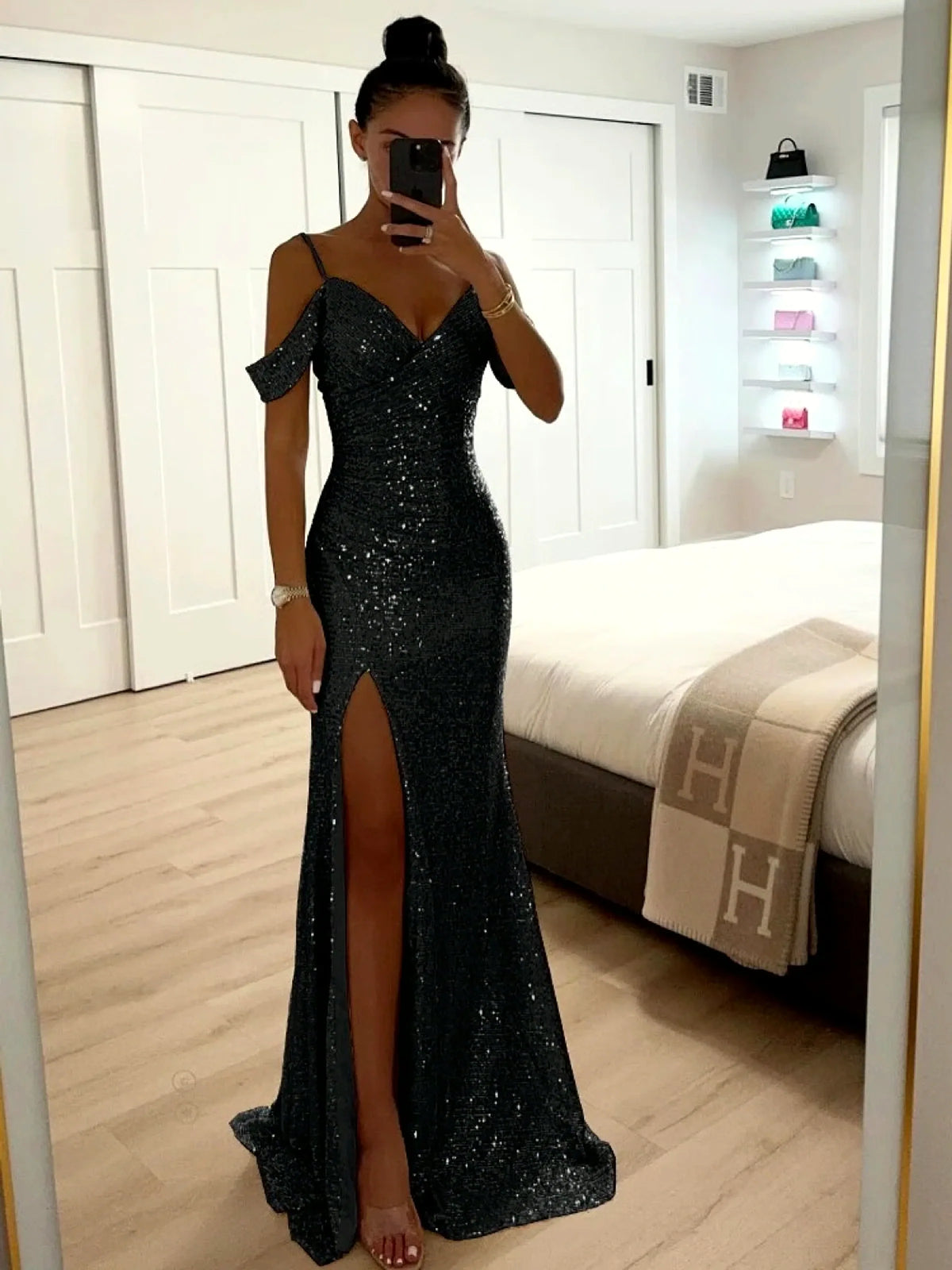 Women's sequin cold-shoulder slit evening gown in black, front mirror view.