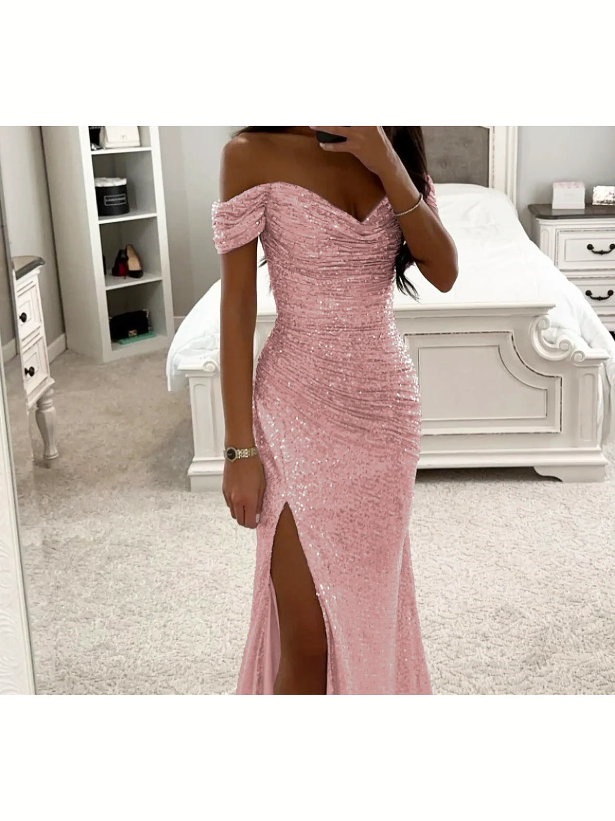 Women's sequin off-shoulder slit evening gown in pink, front mirror view.