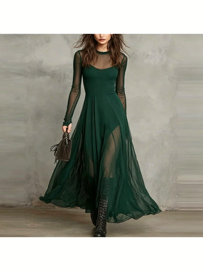Women's sheer long-sleeve flowing maxi dress in green, front model view.