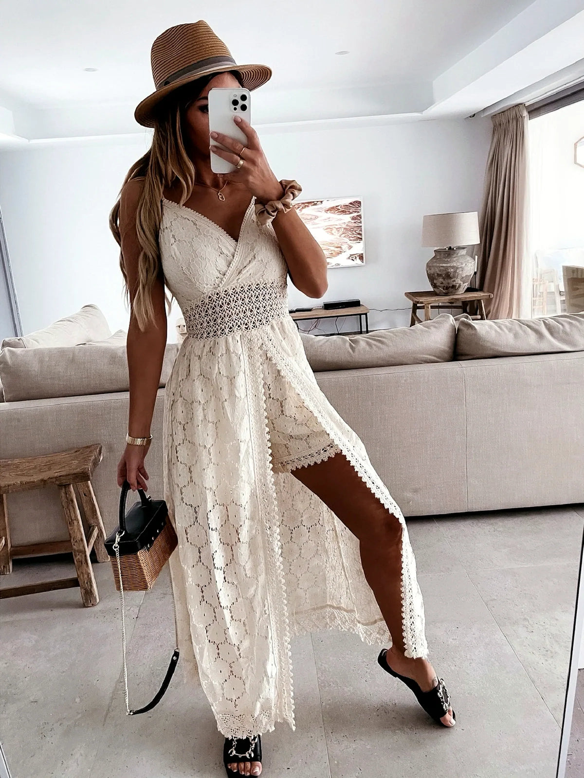Women's sleeveless lace high-low dress in white, high-low hem model view.