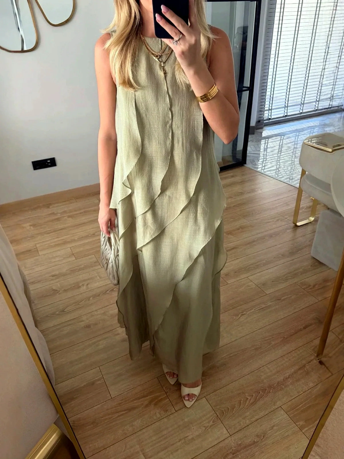 Women's sleeveless layered ruffle maxi dress in sage green, front mirror view.