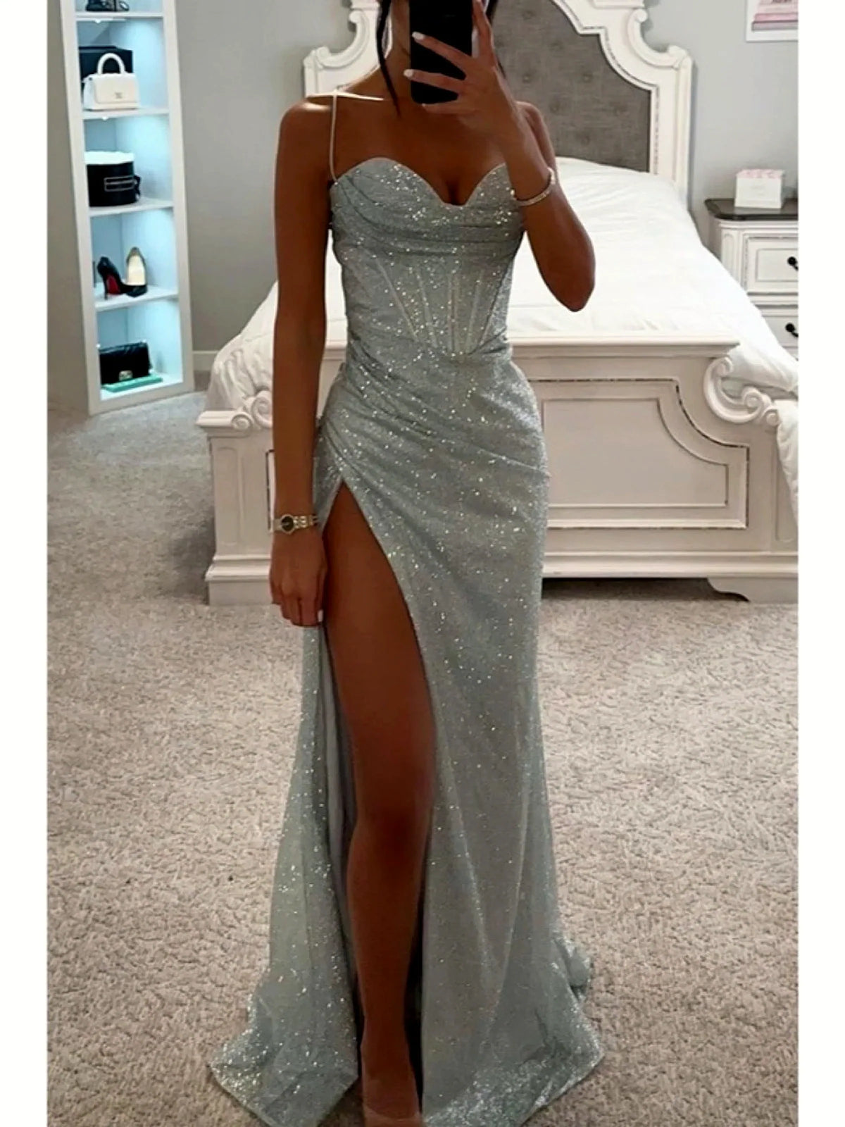 Women's strapless sweetheart slit evening gown in silver, front mirror view.