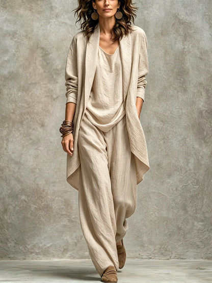Women’s apricot textured asymmetric top and wide-leg pants set with an open-front layer, showing the fabric texture.