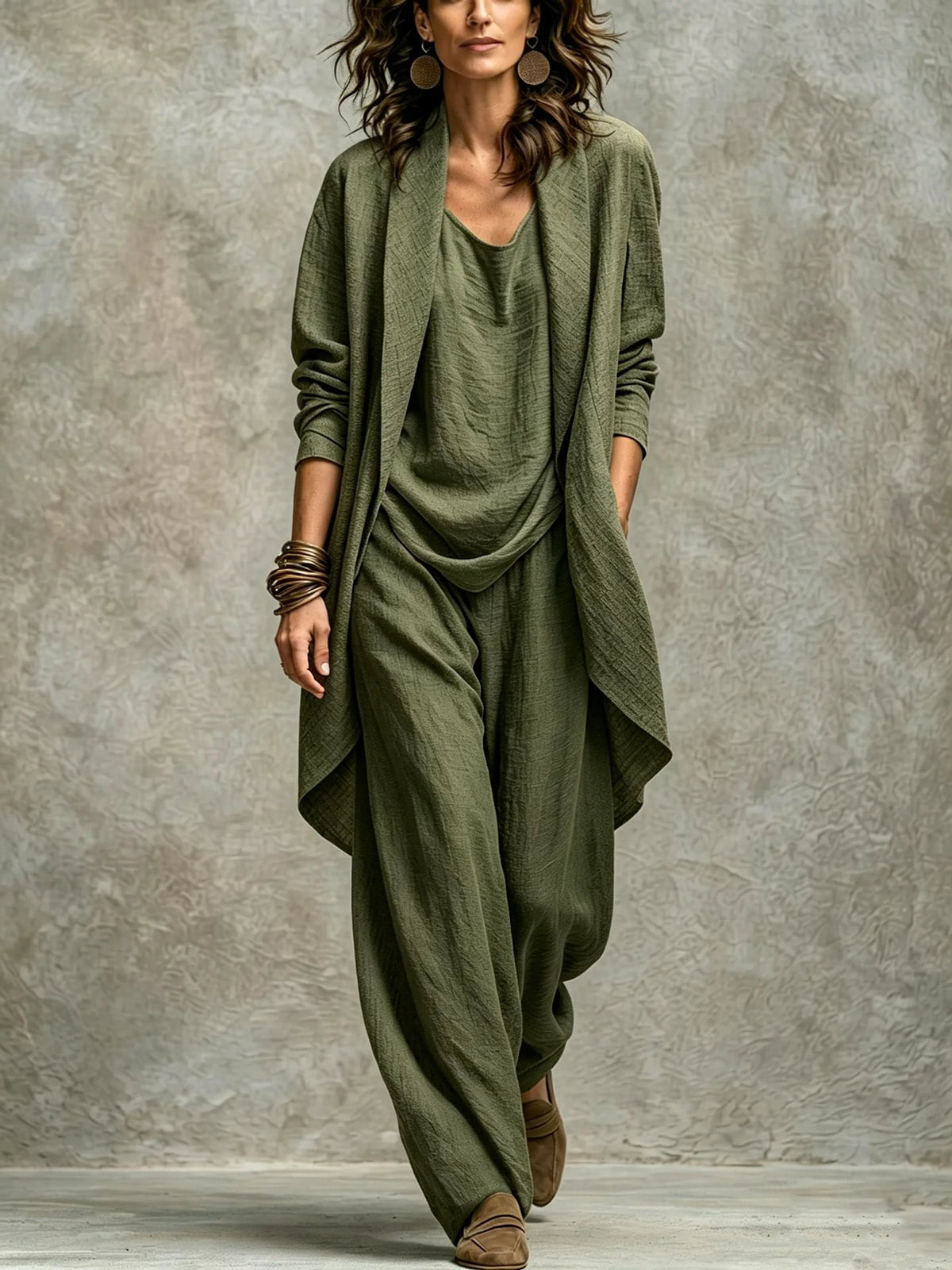 Women’s army green textured asymmetric top and wide-leg pants set with an open-front layer and natural fabric folds.