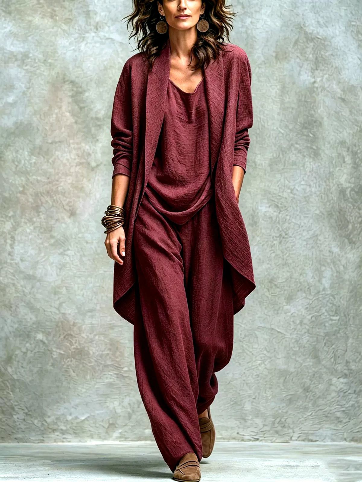 Women’s burgundy textured asymmetric top and wide-leg pants set with an open-front layer, shown on a model.