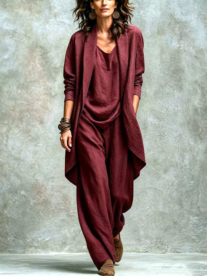 Women’s burgundy textured asymmetric top and wide-leg pants set with an open-front layer, shown on a model.