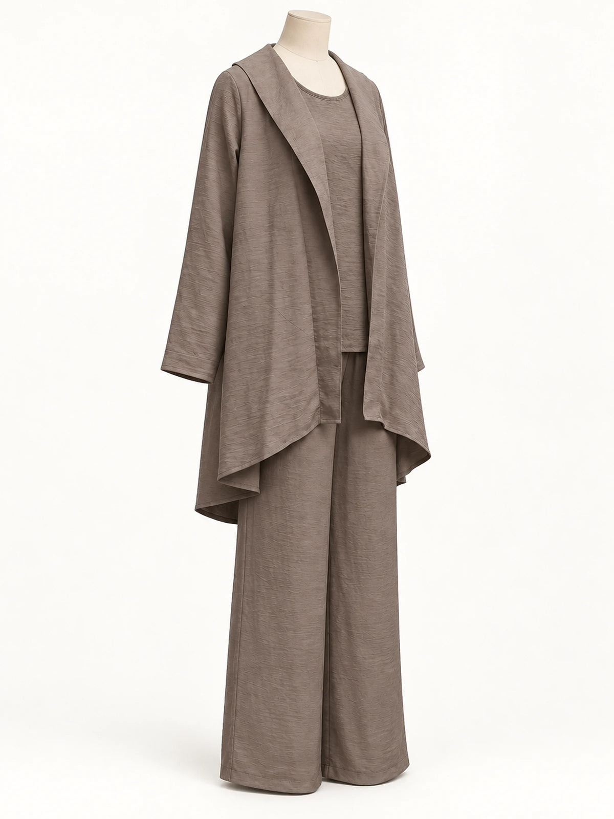 Taupe textured asymmetric outfit with an open-front layer and wide-leg pants, shown on a mannequin from a three-quarter angle.