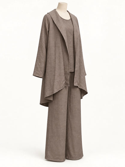 Taupe textured asymmetric outfit with an open-front layer and wide-leg pants, shown on a mannequin from a three-quarter angle.