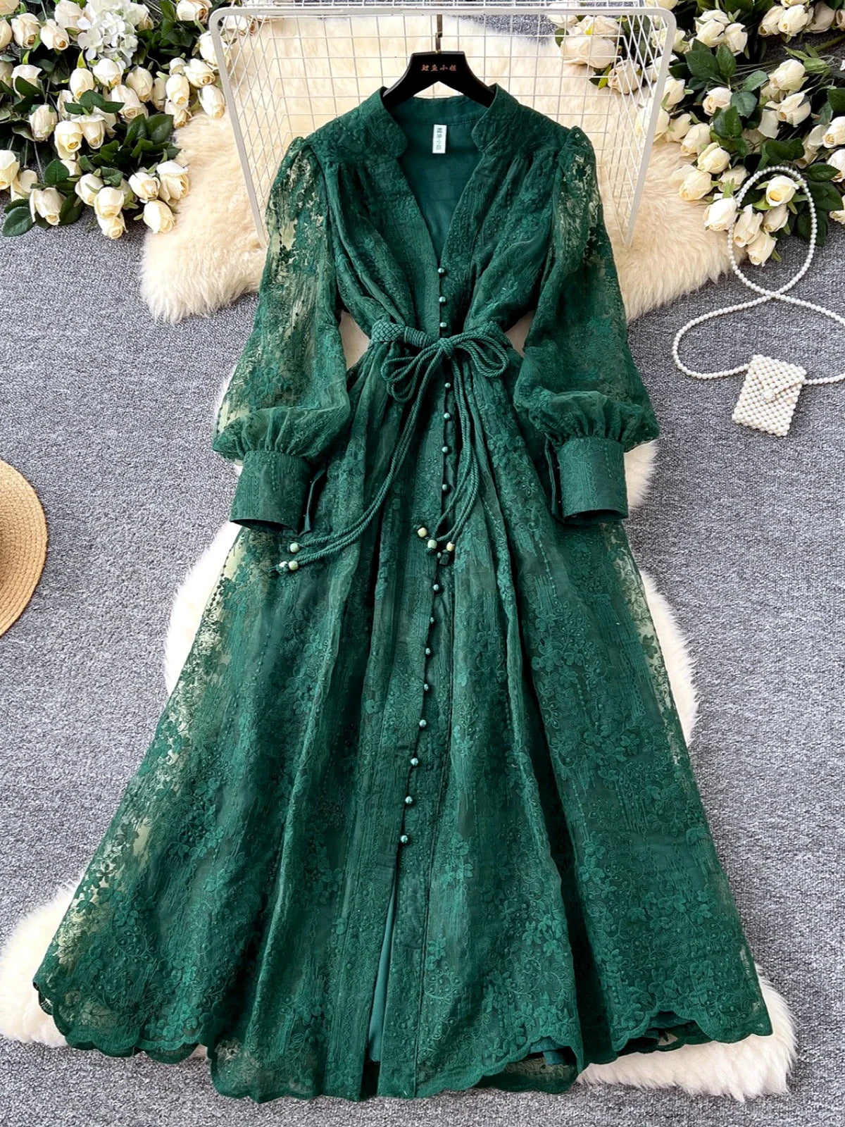 Women's V-neck floral lace long-sleeve dress in green, hanging product view.