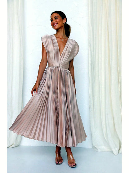 Women's V-neck pleated midi dress in champagne, front twirl view.