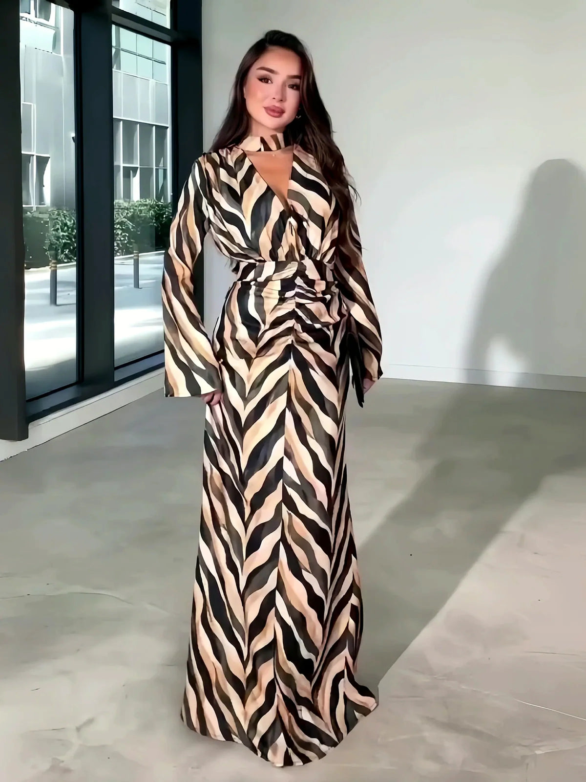 Women's zebra-print long-sleeve maxi dress in beige and black, alternate front model view.